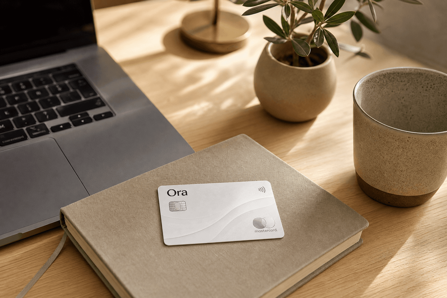 A calm command center with the Ora card and a laptop in one place