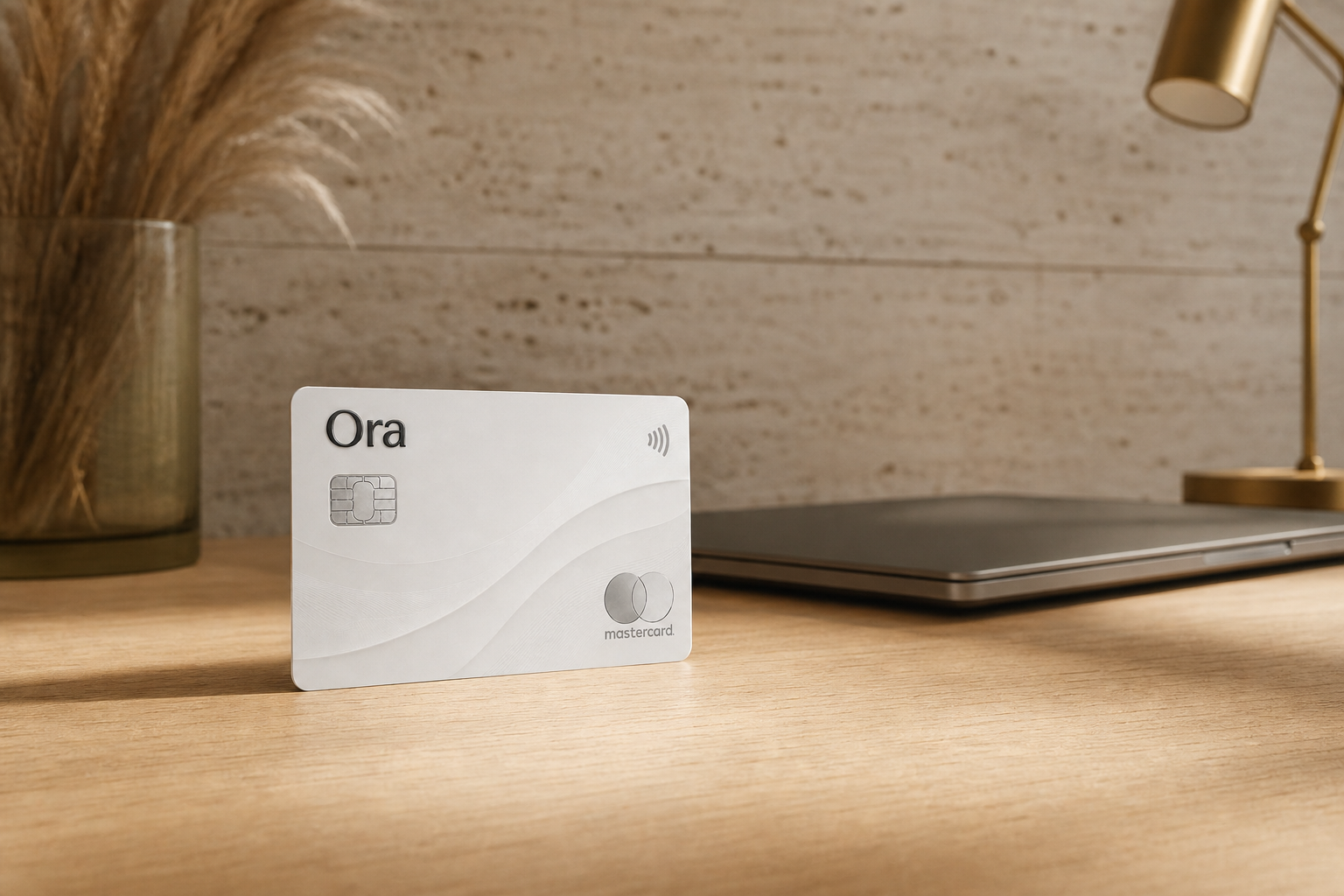 An Ora card standing on a sunlit oak desk in a calm home office