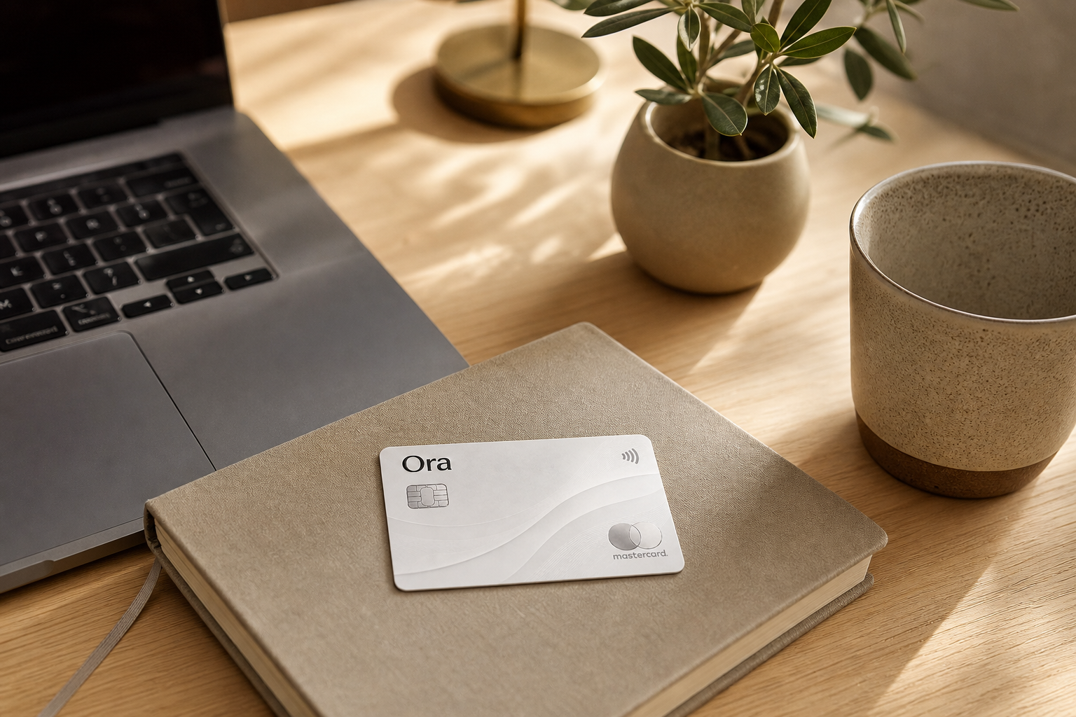 A calm command center with the Ora card and a laptop in one place